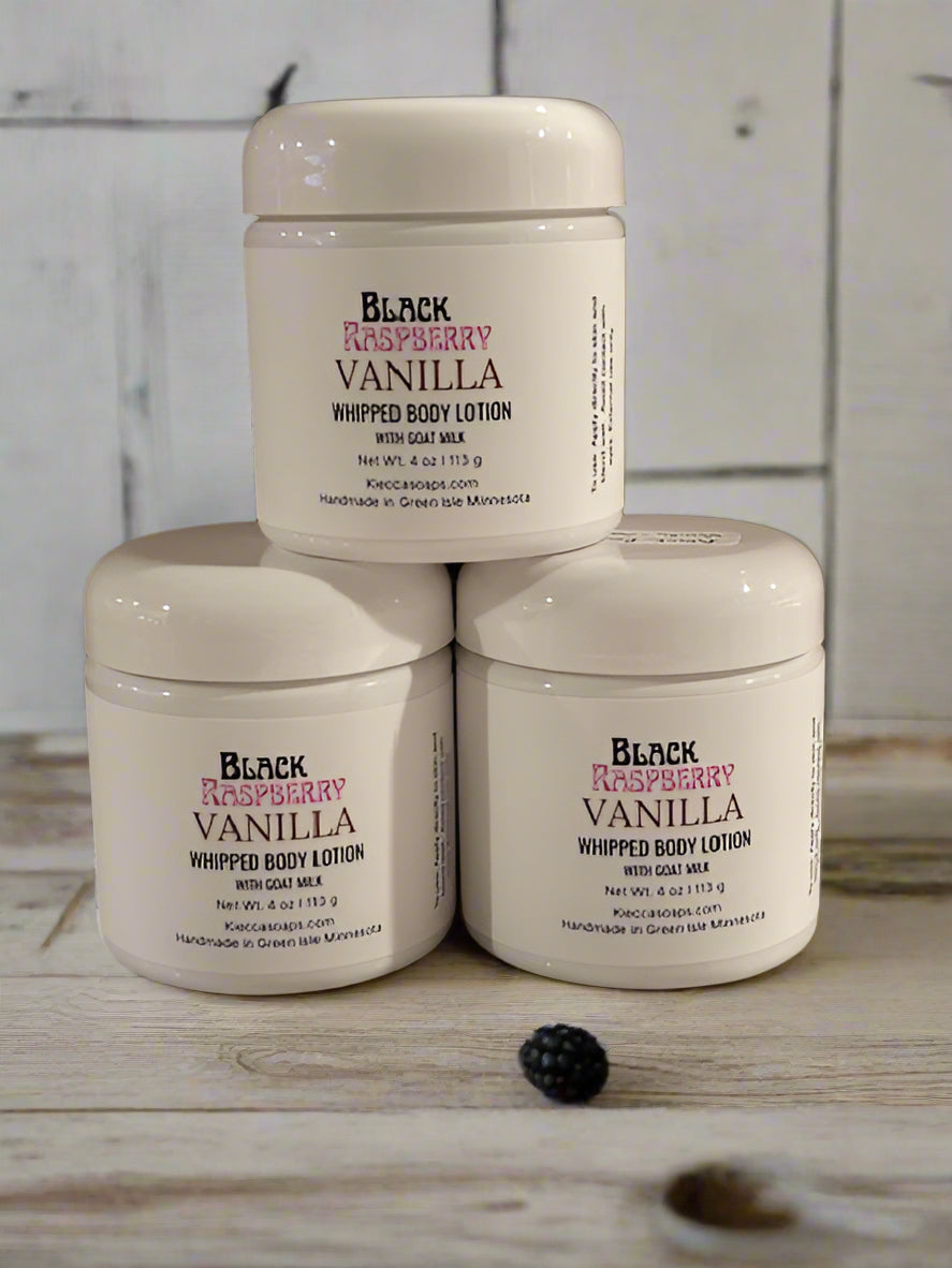 Three containers of Black Raspberry Vanilla whipped body lotion on a textured surface.