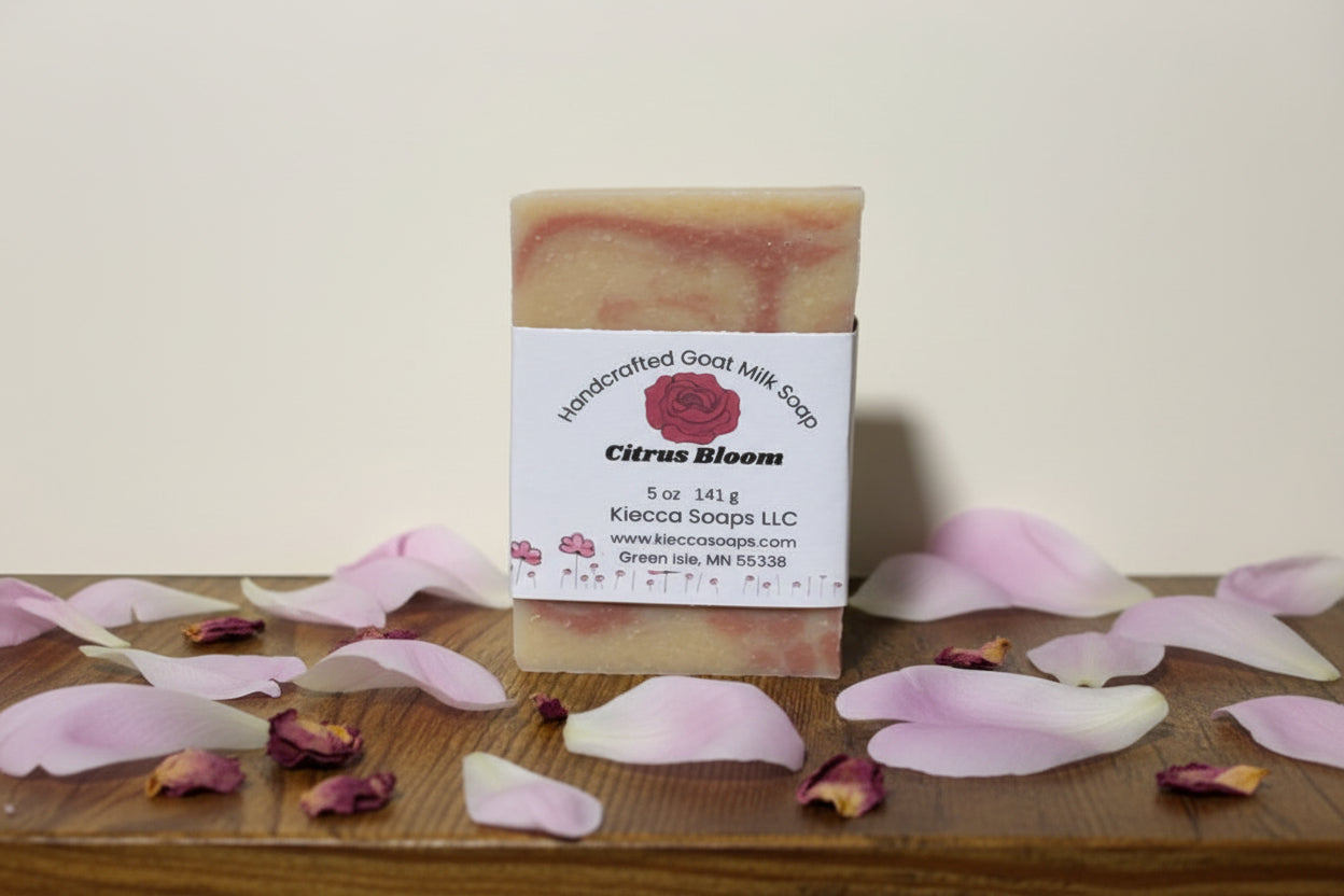 bar of soap with pink swirls. Sitting on a wooden shelf decorated with rose and peony Petels. 