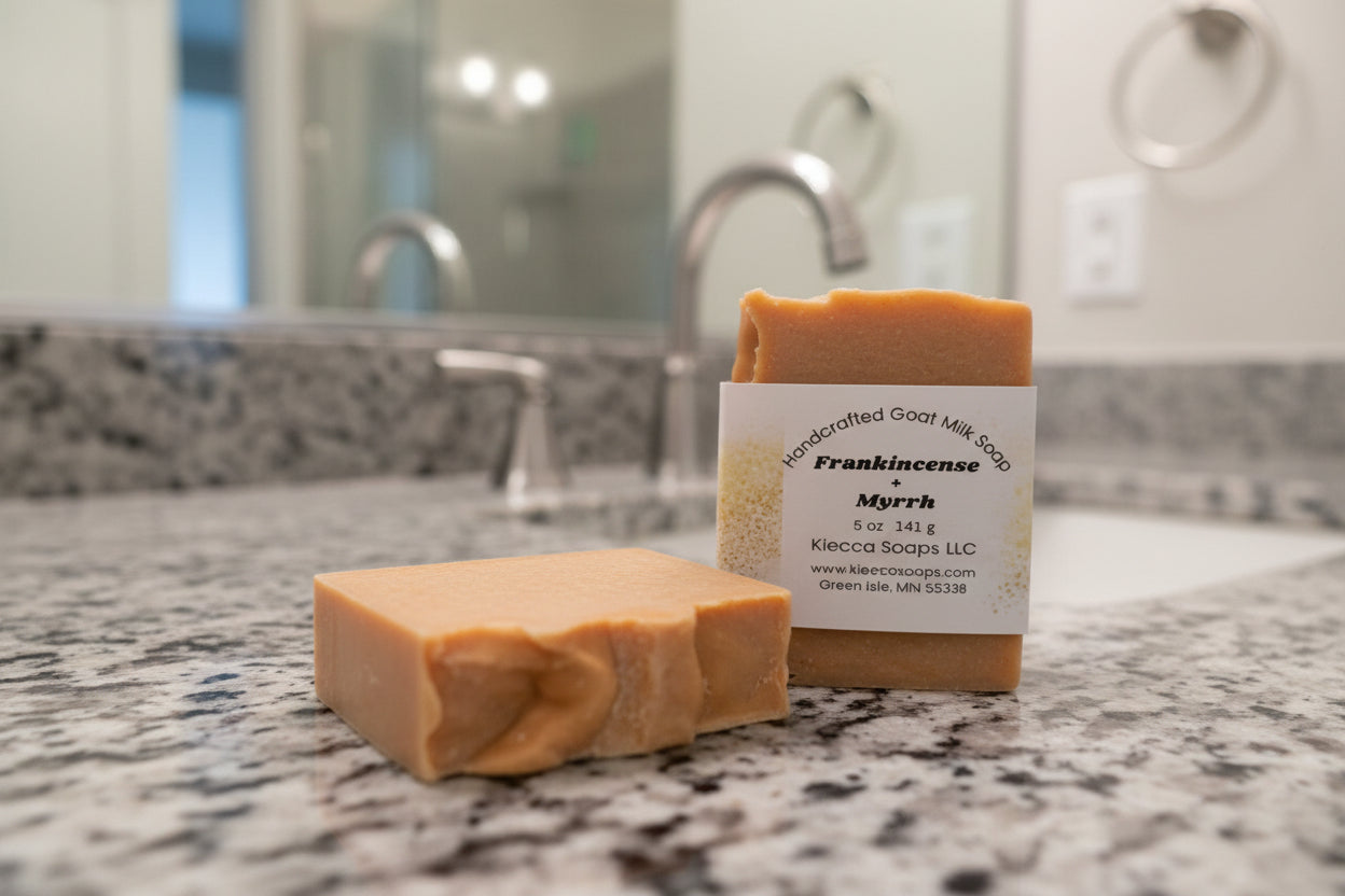 Two bars of soap, one with label on wooden surface.